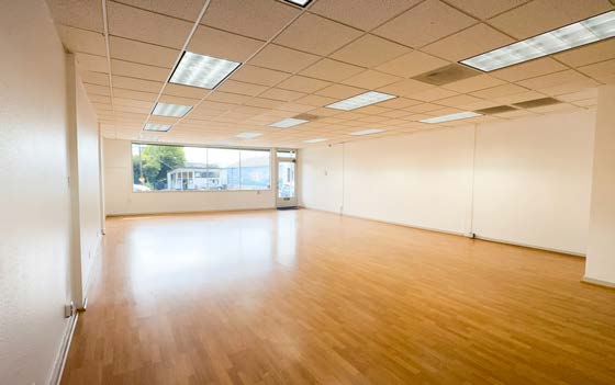 Open sales floor with natural light from the full glass line
